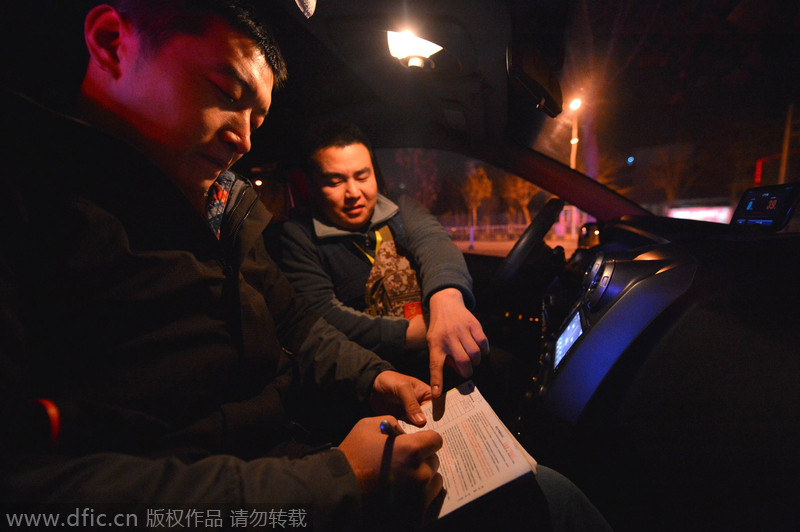 El conductor?privado?Li?Xiaodong?pide?a un?cliente?que rellenar?un?formulario?en?Shijiazhuang, provincia?de?Hebei,?el 17 de diciembre de?2014.?[Foto/IC]