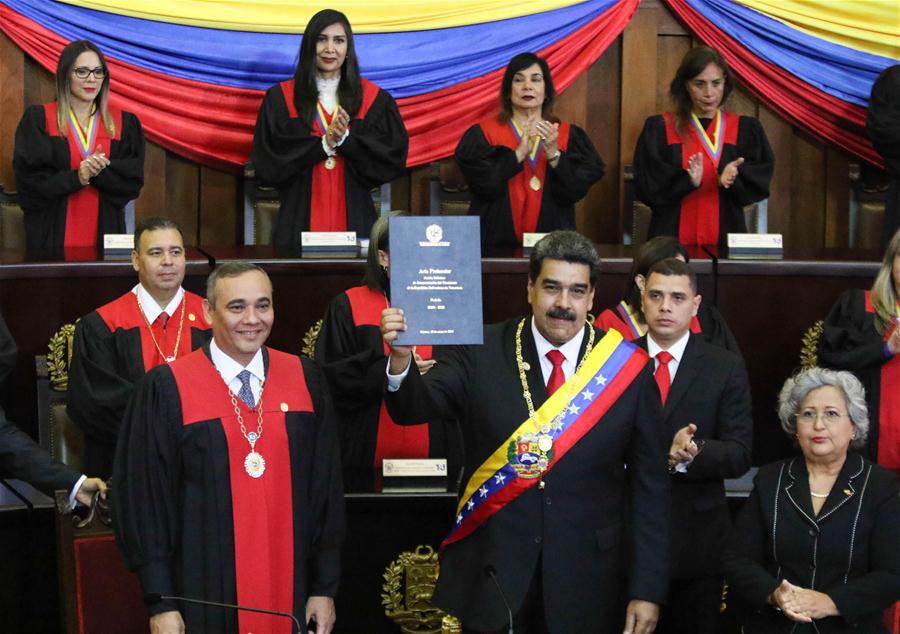 Imagen cedida por la Presidencia de Venezuela, del presidente venezolano, Nicolás Maduro (c-frente), sosteniendo el acta durante la ceremonia de juramentación como presidente de Venezuela, en Caracas, Venezuela, el 10 de enero de 2019. El presidente venezolano, Nicolás Maduro, se juramentó el jueves ante el Tribunal Supremo de Justicia (TSJ), para ejercer un nuevo mandato para el período 2019-2025. Maduro expresó ante el presidente del TSJ, Maikel Moreno, que juraba a nombre del pueblo de Venezuela que cumpliría y haría cumplir todos los mandatos constitucionales para "procurar defender la independencia y la integridad absoluta de la patria". (Xinhua/Presidencia de Venezuela)