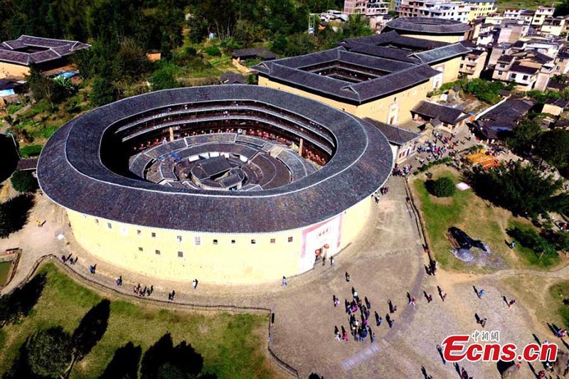 Esta foto sin fecha muestra a personas que visitan Fujian Tulou en la provincia de Fujian. (Foto / Wang Dongming)